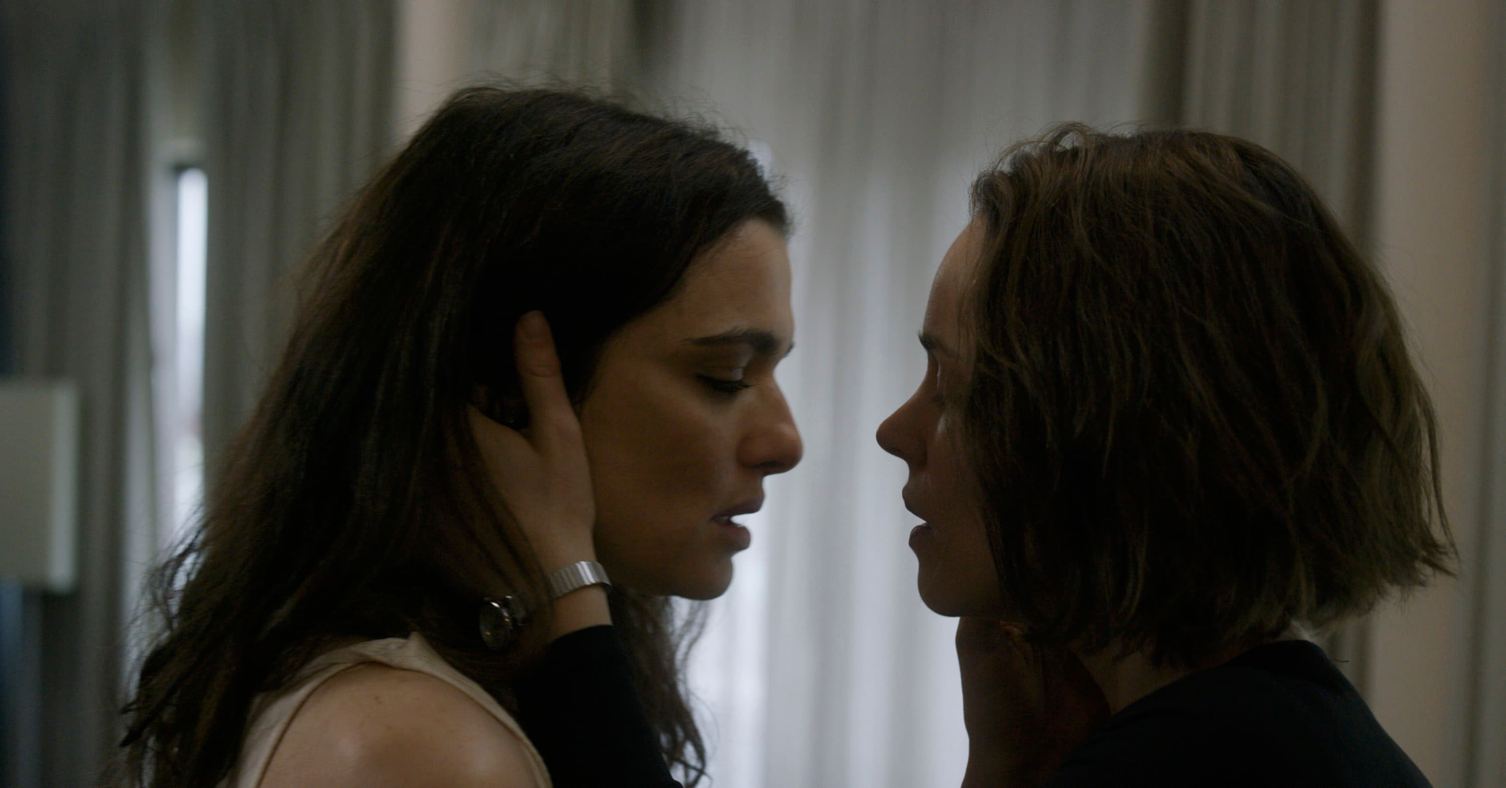 Ronit and Esti are very close, about to kiss.